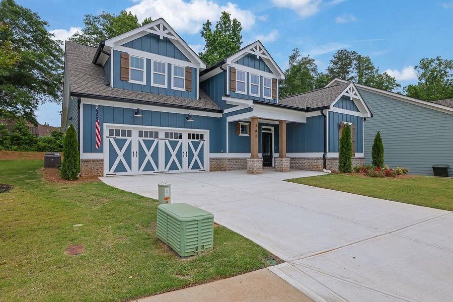 Front exterior of a new home in , Holly Springs, GA, highlighting curb appeal (Image 25). Front exterior of a new home in , Holly Springs, GA, highlighting curb appeal (Image 25).