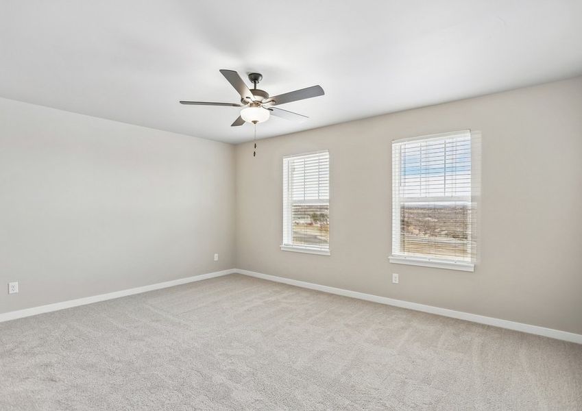 The master bedroom has large windows and a ceiling fan.