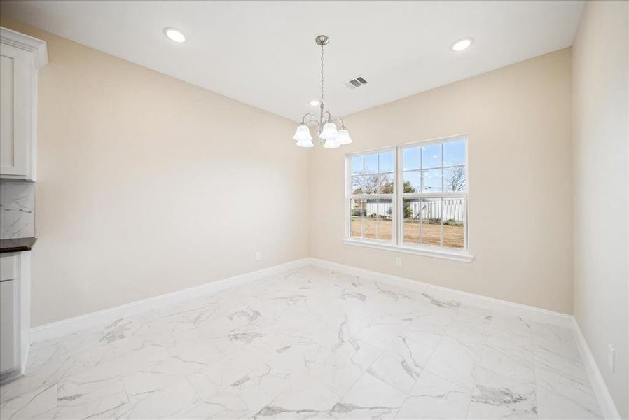 Unfurnished dining area with a notable chandelier