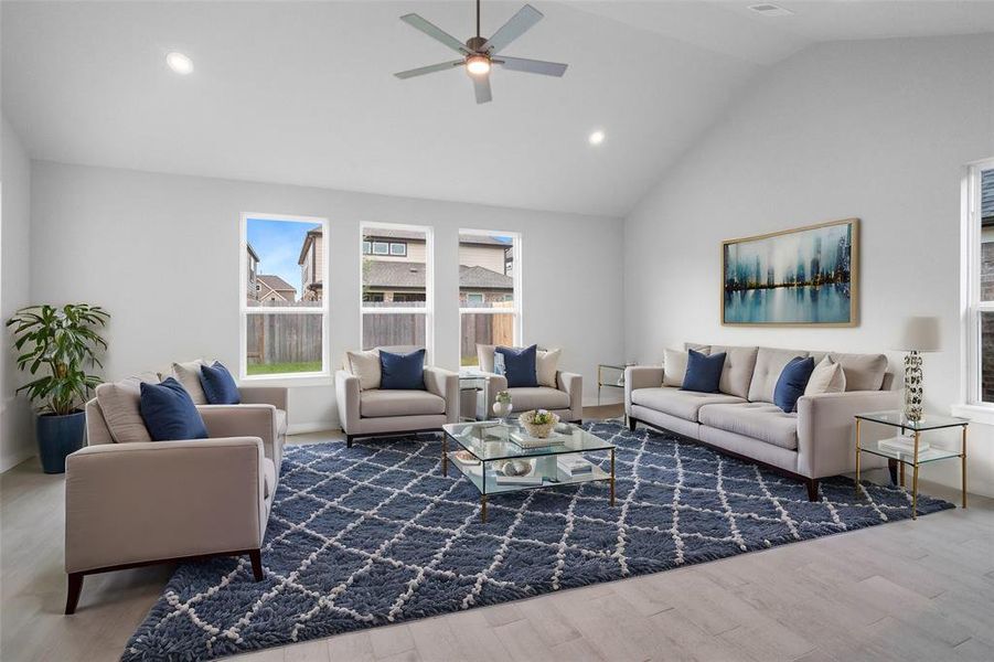 Gather the family and guests together in your lovely living room! Featuring high ceilings, recessed lighting, ceiling fan, custom paint, gorgeous floors and large windows that provide plenty of natural lighting throughout the day.