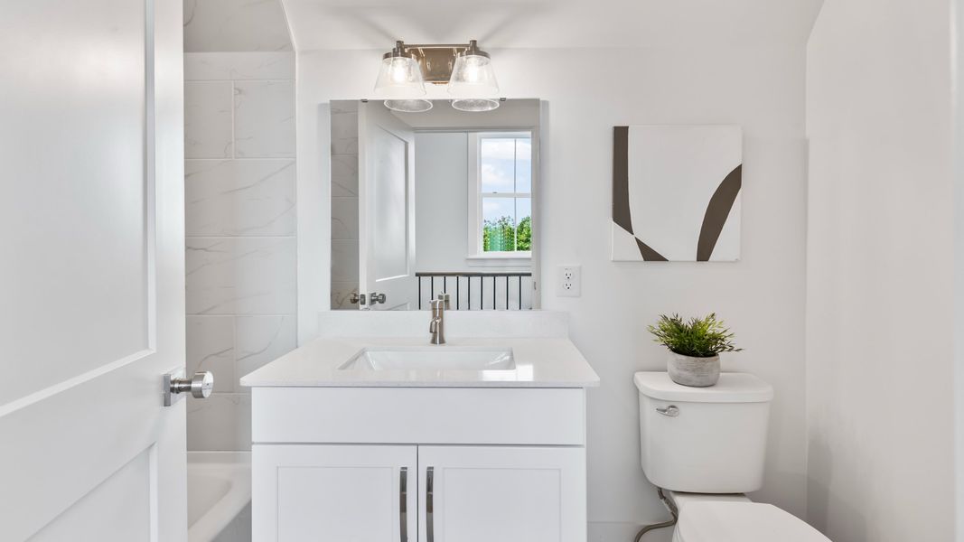Secondary bathroom in the Sullivan home plan with modern fixtures and bright finishes.