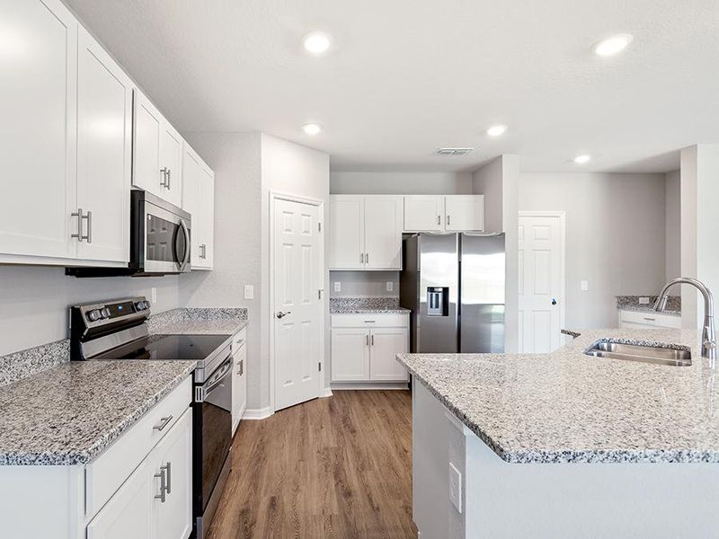 Enjoy ample counter and cabinet space, plus a walk-in pantry.