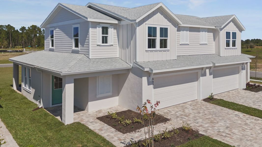 Monterey elevation at Cyrene at Harmony — a spacious two-story design with a two-car garage and coastal exterior charm.