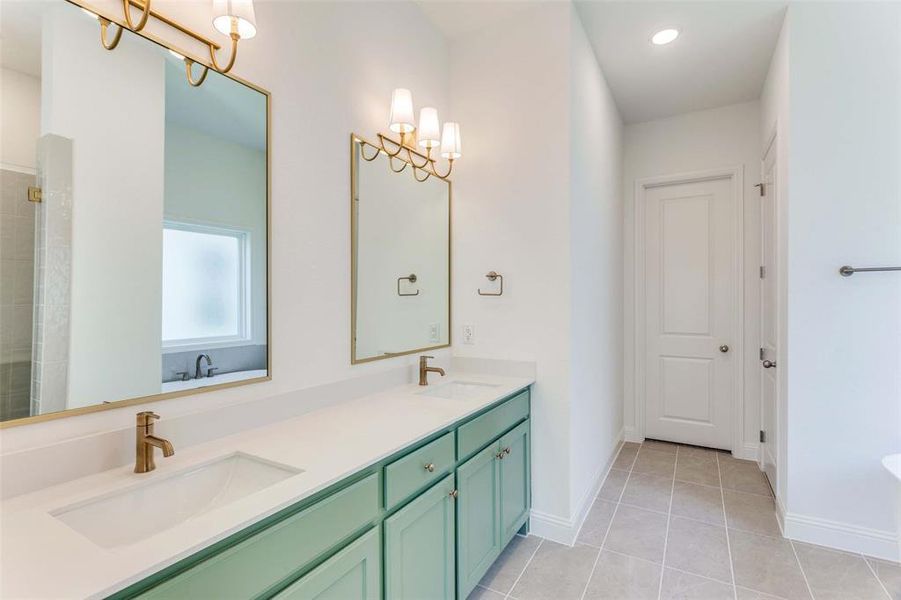 Bathroom with tile patterned floors and vanity