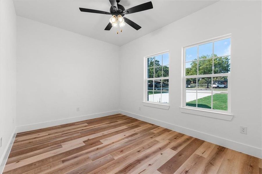 Spare room featuring ceiling fan and light hardwood / wood-style floors