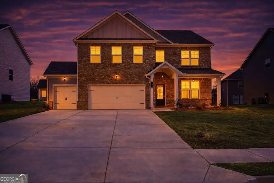 Front exterior of a new home in The Fairways at Mirror Lake, Villa Rica, GA, highlighting curb appeal (Image 2). Front exterior of a new home in The Fairways at Mirror Lake, Villa Rica, GA, highlighting curb appeal (Image 2).