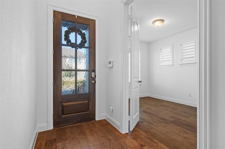 Foyer with dark wood-type flooring