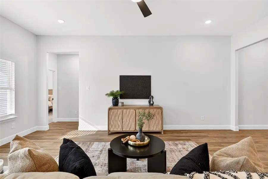 Living area featuring light wood finished floors, recessed lighting, and ceiling fan