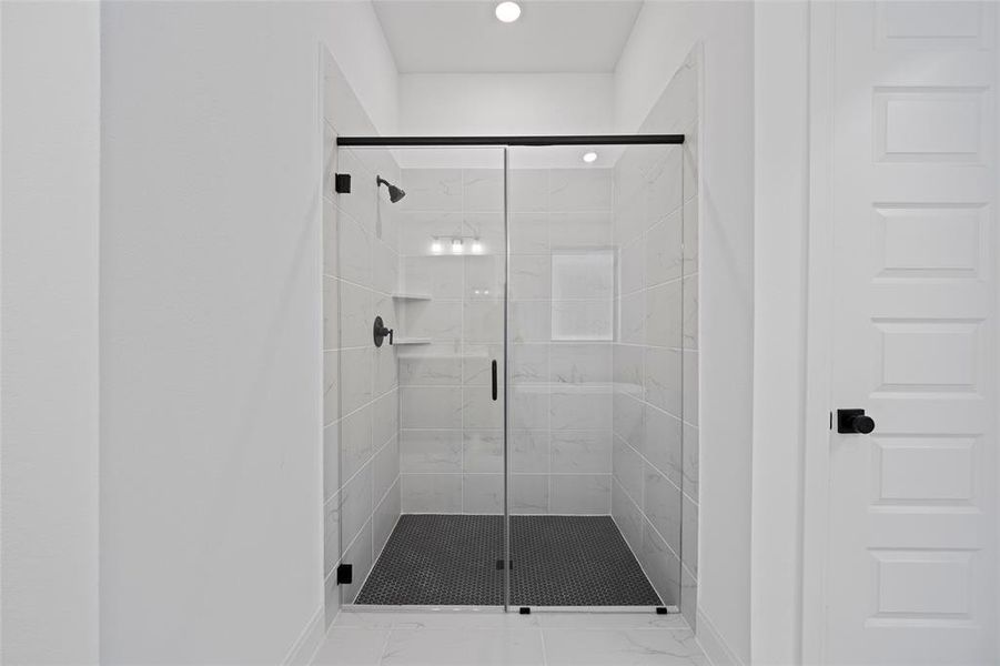 Bathroom featuring a shower with shower door