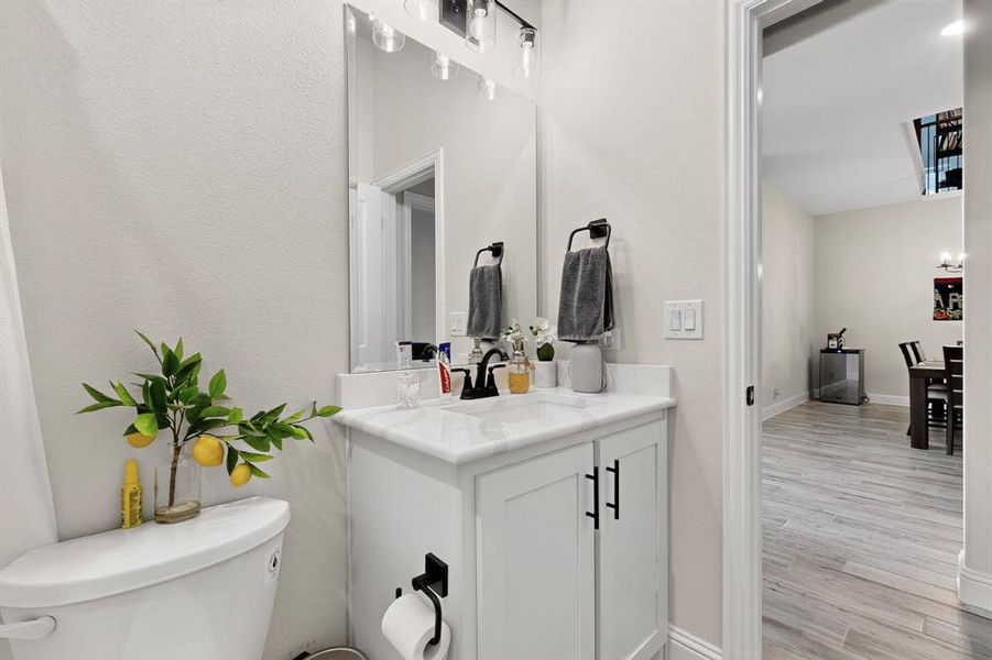 Bathroom featuring vanity, light wood-style flooring, and a chandelier Bathroom featuring vanity, light wood-style flooring, and a chandelier