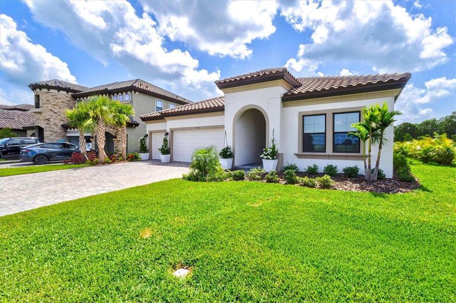 Front exterior of a new home in Crosswind Ranch, Parrish, FL, highlighting curb appeal (Image 31).