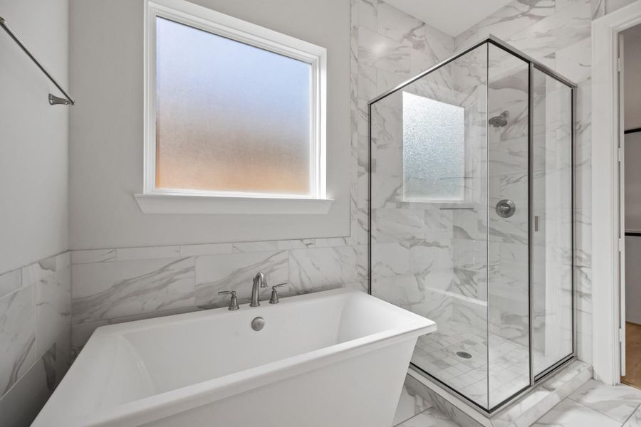 Primary Bathroom with soaking tub and glass enclosed shower
