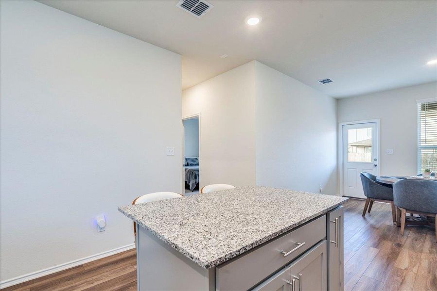 Kitchen features stainless appliances, center island, granite counters, LVP and recessed lighting Kitchen features stainless appliances, center island, granite counters, LVP and recessed lighting