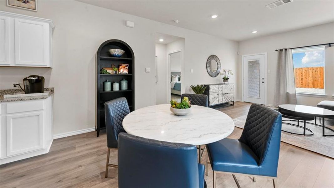 Dining space with light wood-style floors and recessed lighting Dining space with light wood-style floors and recessed lighting
