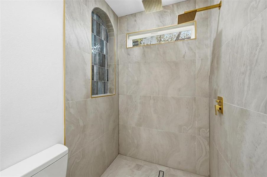 Luxurious primary shower with frameless glass, dual rain shower heads, deisgner arch Luxurious primary shower with frameless glass, dual rain shower heads, deisgner arch