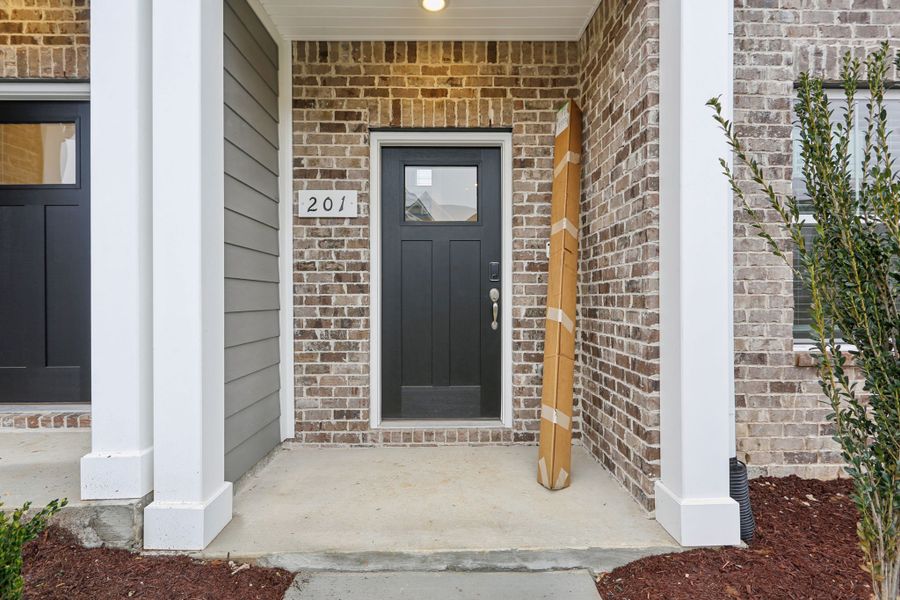 Exterior details and patio area of a home in Greystone - Highland Townhomes, Smyrna (Image 3).