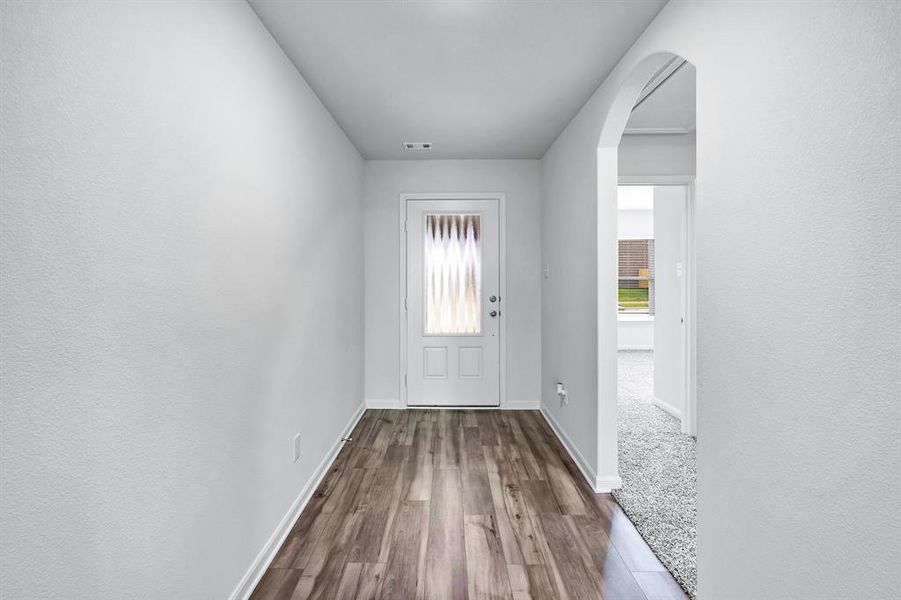 Doorway to outside featuring carpet floors