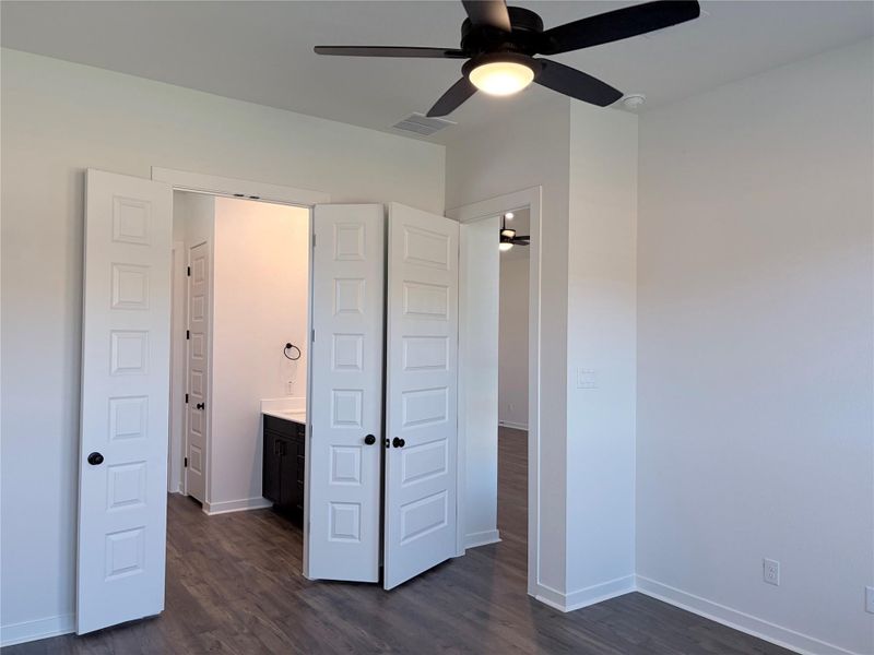 Gleaming wood floors anchor this bedroom, offering seamless access to an adjacent private bathroom. Gleaming wood floors anchor this bedroom, offering seamless access to an adjacent private bathroom.