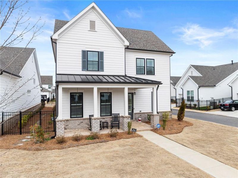 Front exterior of a new home in Promenade at Sawnee Village, Cumming, GA, highlighting curb appeal (Image 24).