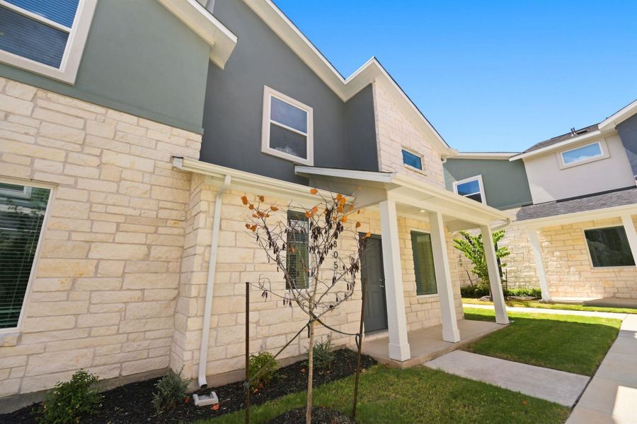 Modern stone and stucco details enhance the architectural character of this two-story exterior facade.