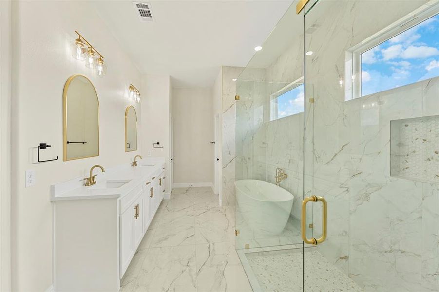 Bathroom featuring recessed lighting, double vanity, a marble finish shower, light marble finish flooring, and a freestanding bath