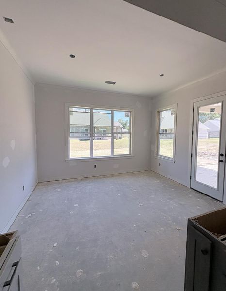 Recessed ceiling lighting, multiple windows, and a glass-paneled door