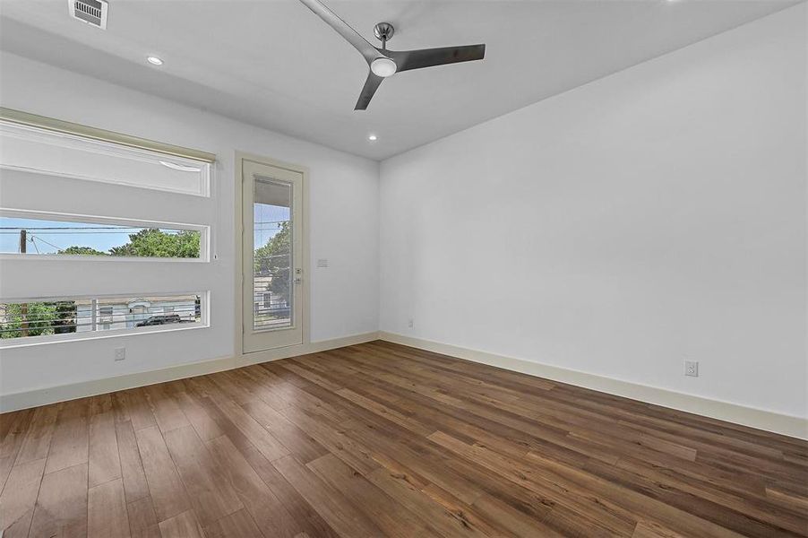 Unfurnished room featuring wood-type flooring and ceiling fan