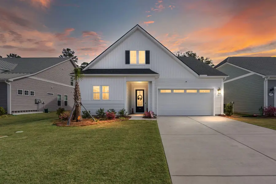 Front exterior of a new home in Summerwind Crossing at Lakes of Cane Bay, Summerville, SC, highlighting curb appeal (Image 23).
