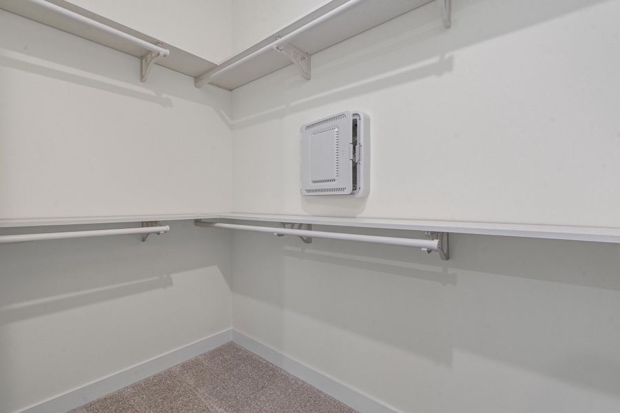 Walk in closet with light carpet