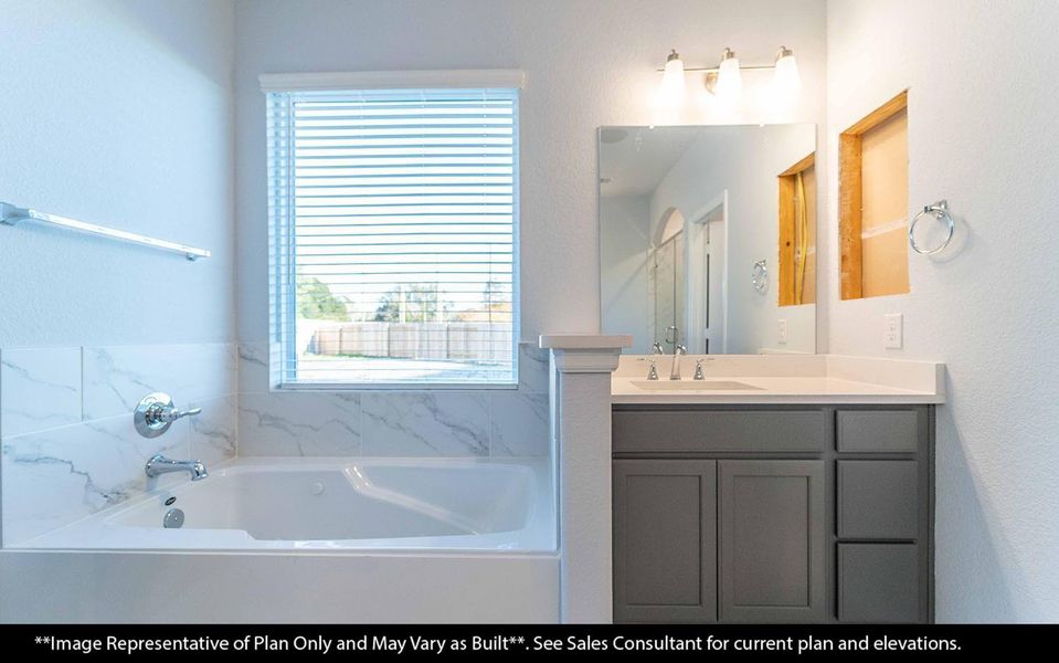 A closer look at the relaxing soaking tub surrounded by bright natural light. The thoughtful design of this primary bath creates a soothing retreat for unwinding in style. **Image Representative of Plan Only and May Vary as Built**.