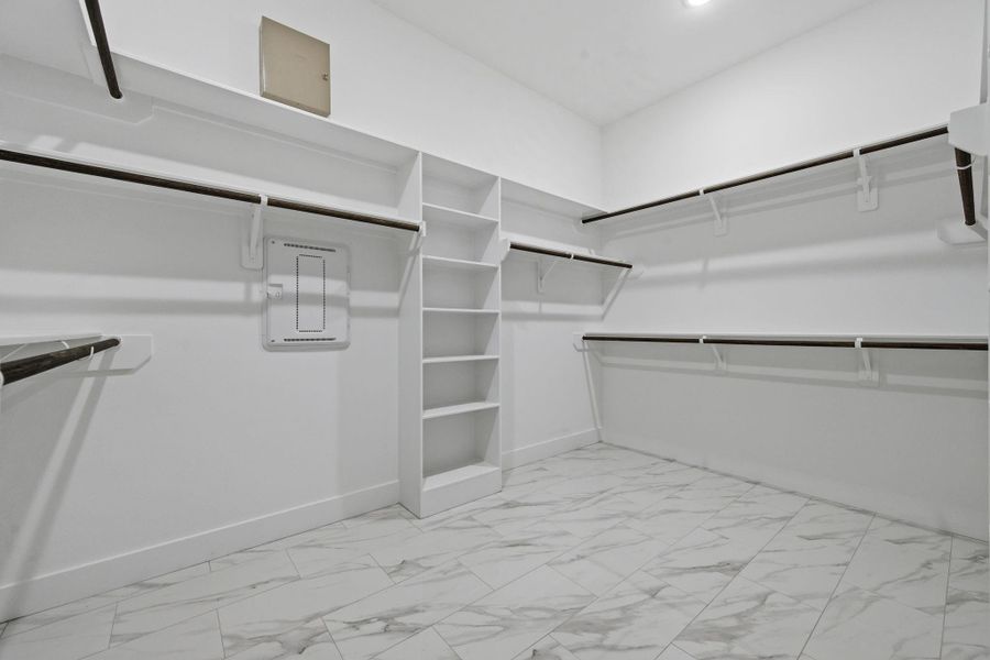 Large primary closet with build ins. Large primary closet with build ins.