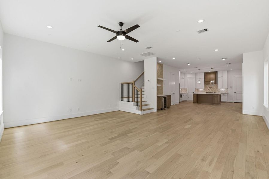 Expansive first-floor layout offeringseamless flow between the diningarea, kitchen, and living spaces. (Photo of a previous build, similar finishes.)