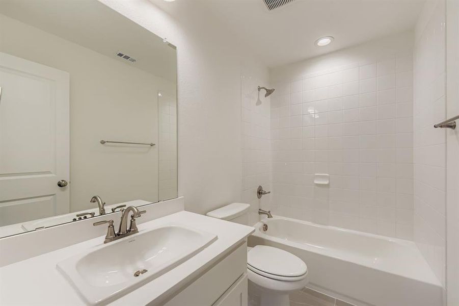 Full bathroom with shower / bathtub combination, vanity, and recessed lighting Full bathroom with shower / bathtub combination, vanity, and recessed lighting