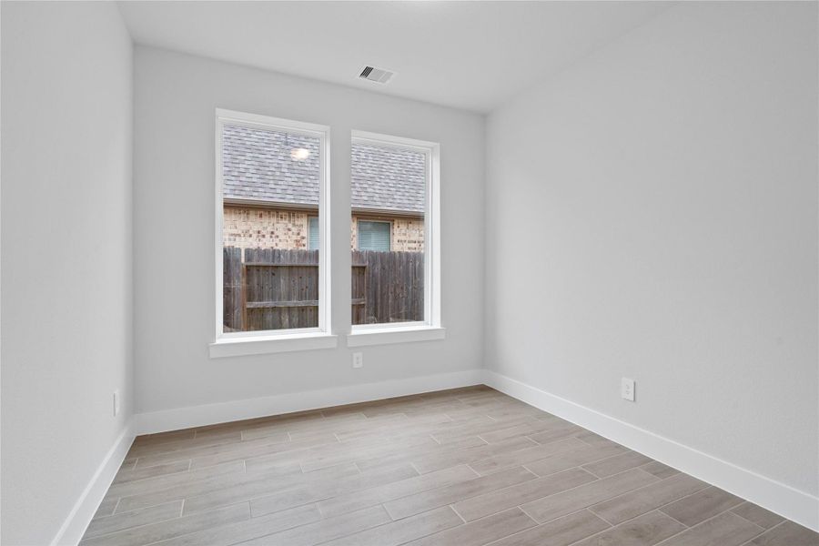 The Study offers a quiet workspace with wood flooring, high ceilings, double doors for added privacy, large windows, and custom paint for a polished finish.