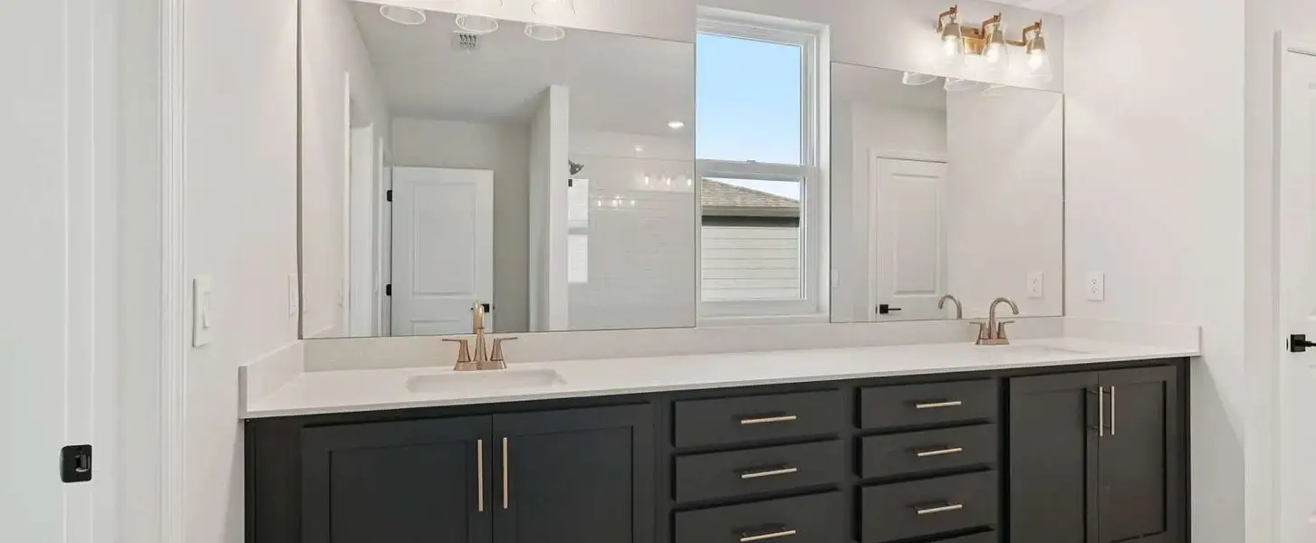 Primary bathroom featuring double sinks - representative image this home will feature AW Collection® Laguna Primary bathroom featuring double sinks - representative image this home will feature AW Collection® Laguna
