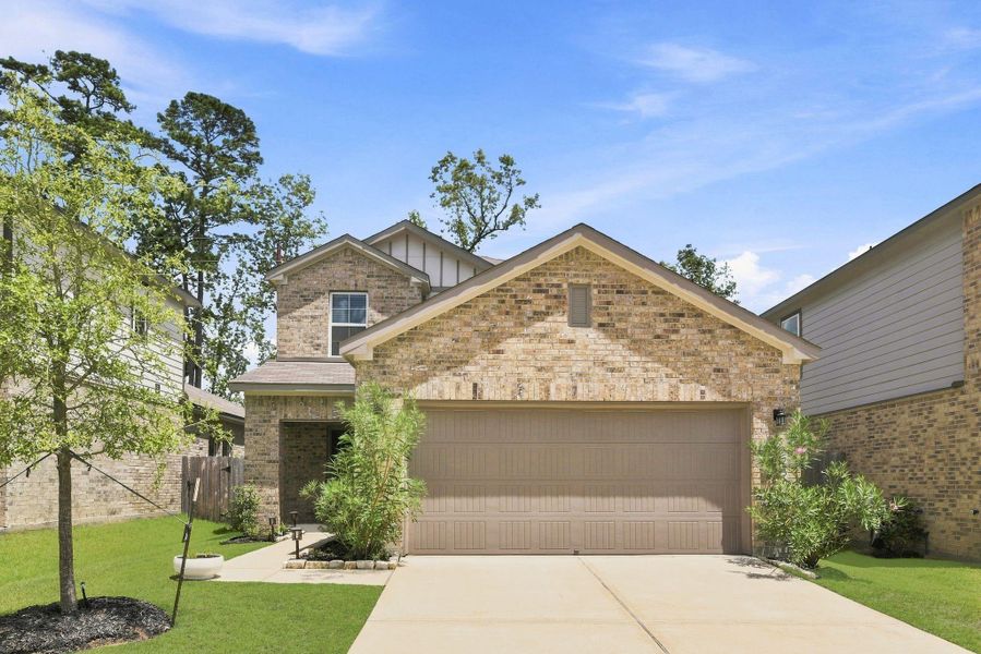 Front exterior of a new home in Lakes at Black Oak, Magnolia, TX, highlighting curb appeal (Image 2). Front exterior of a new home in Lakes at Black Oak, Magnolia, TX, highlighting curb appeal (Image 2).