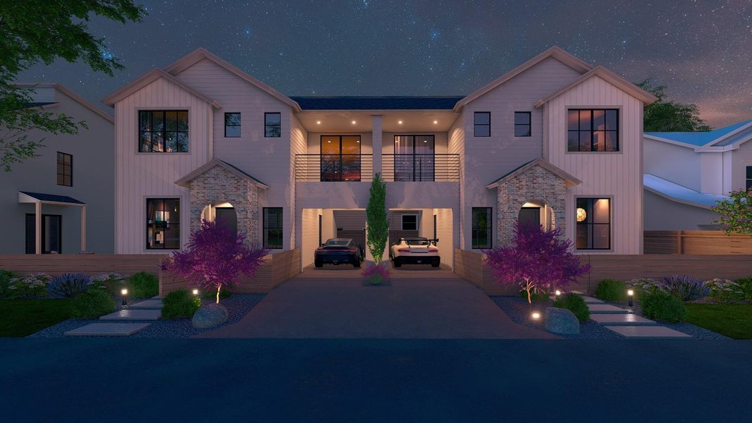 View of front facade with a balcony, stone siding, and driveway