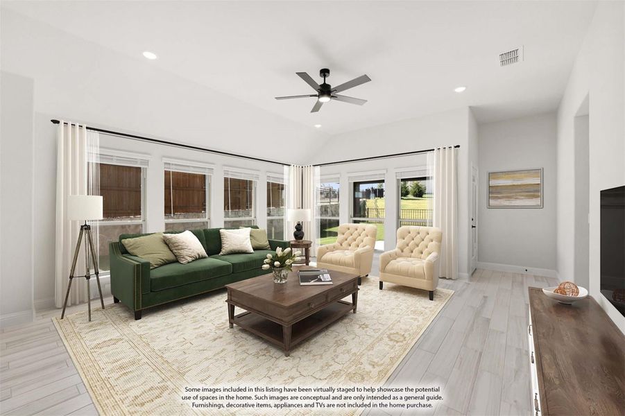 Bright living room with vaulted ceiling, ceiling fan, green sofa, two accent chairs, and large windows with backyard view. Bright living room with vaulted ceiling, ceiling fan, green sofa, two accent chairs, and large windows with backyard view.