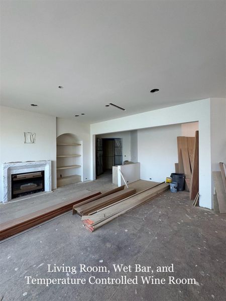 Expansive Living Room featuring a Marble Fireplace, Custom built-ins, and direct access to a Wet Bar and Temperature-Controlled Wine Room.