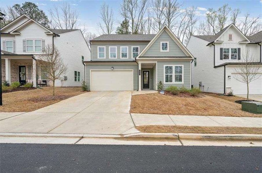 Front exterior of a new home in Enclave at Edgewater, Holly Springs, GA, highlighting curb appeal (Image 28). Front exterior of a new home in Enclave at Edgewater, Holly Springs, GA, highlighting curb appeal (Image 28).