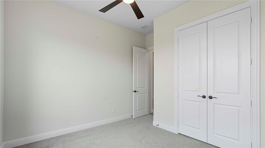 Interior room featuring light-colored walls and carpeted flooring