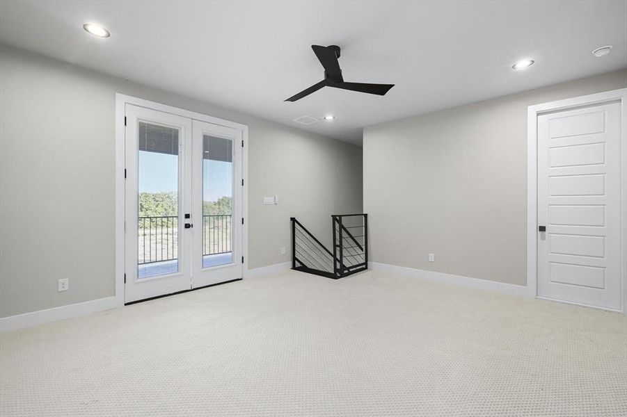 Carpeted empty room with recessed lighting, french doors, and ceiling fan Carpeted empty room with recessed lighting, french doors, and ceiling fan
