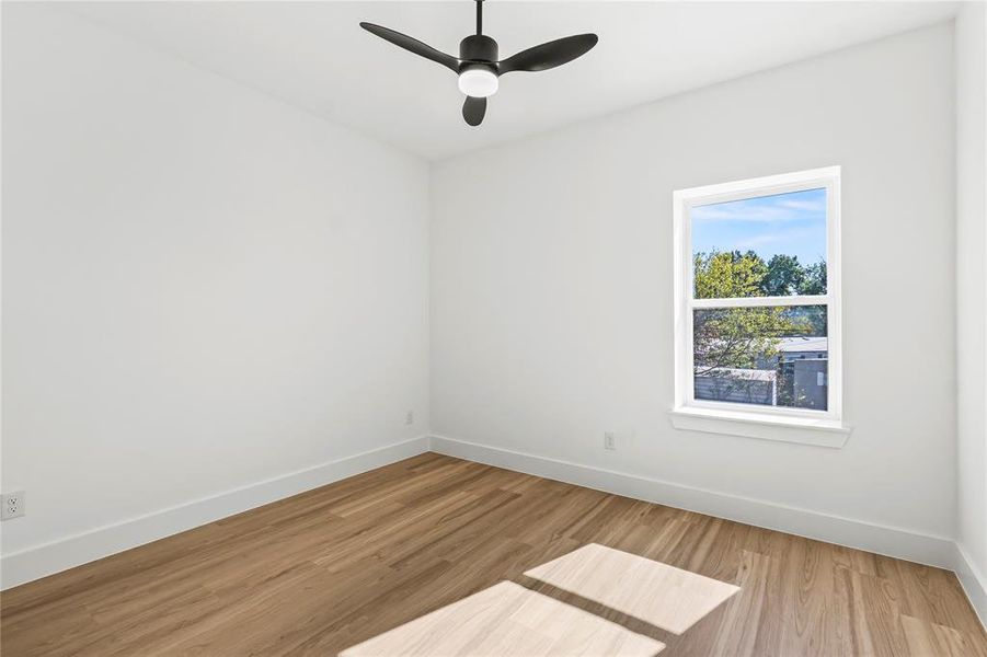 Spare room featuring light wood finished floors and ceiling fan