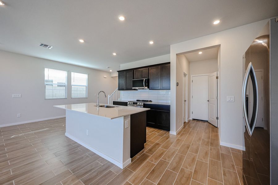 A kitchen with black cabinets. A kitchen with black cabinets.
