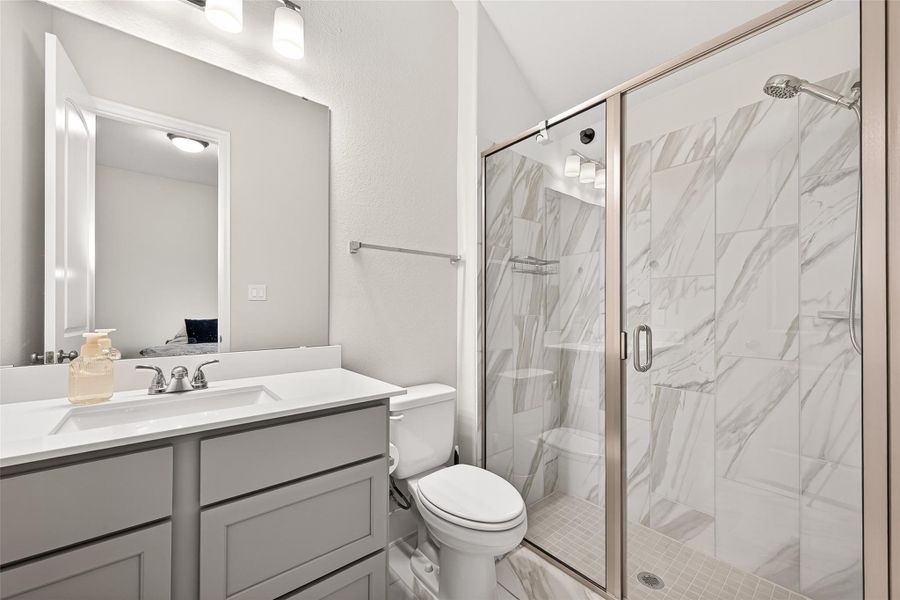 Guest en-suite bathroom featuring a stand-up shower, offering comfort, convenience, and privacy for visitors. Guest en-suite bathroom featuring a stand-up shower, offering comfort, convenience, and privacy for visitors.