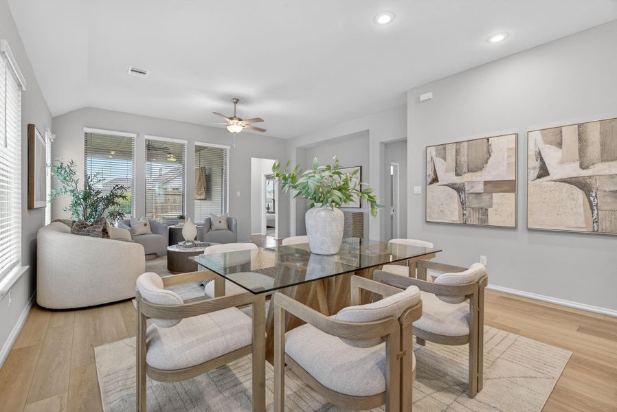 This photo showcases a modern open-concept dining and living area. Large windows throughout this area for natural light. This photo showcases a modern open-concept dining and living area. Large windows throughout this area for natural light.