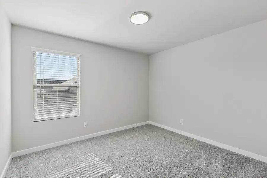 Bedroom in the Holden home plan by Trophy Signature Homes – REPRESENTATIVE PHOTO