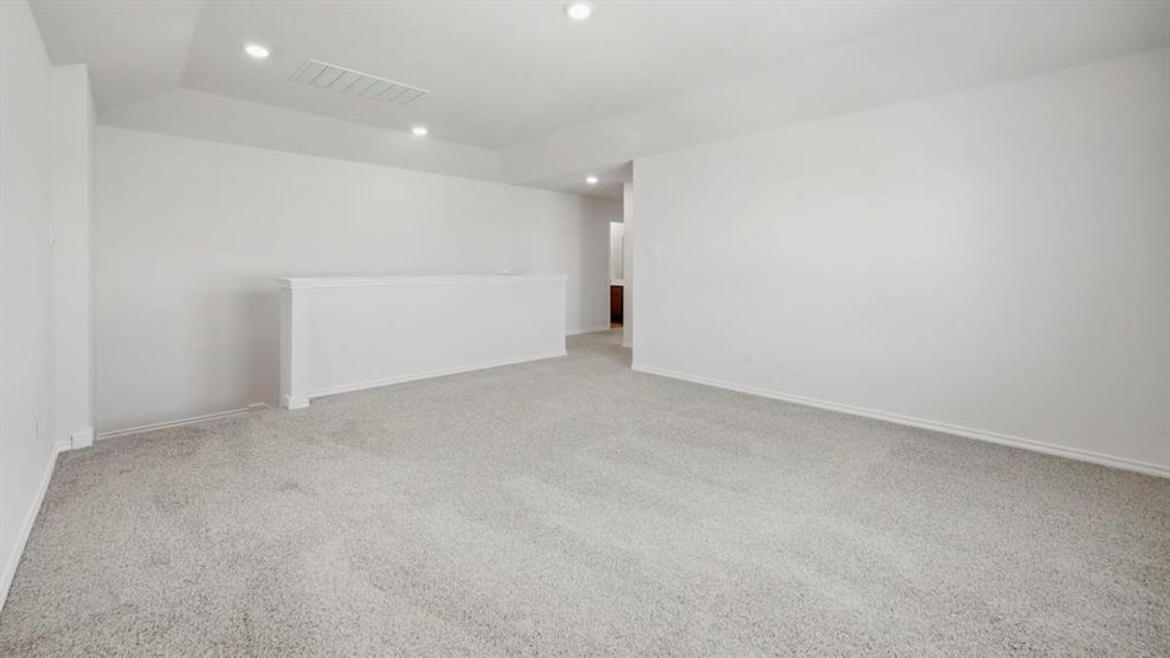 Carpeted spare room featuring recessed lighting
