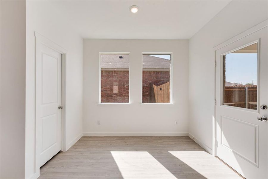 Empty room with a healthy amount of sunlight and light wood-type flooring