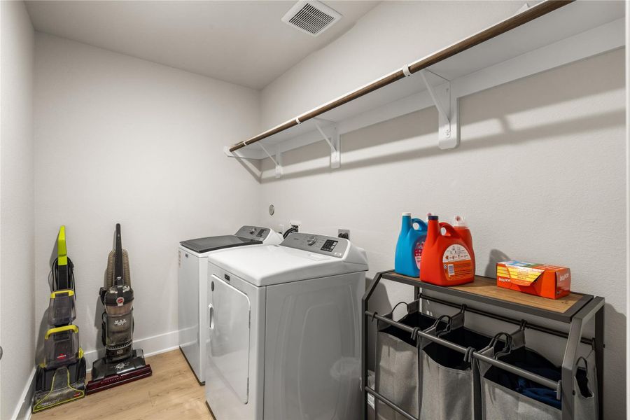 Thoughtfully tucked away from the main living areas, the dedicated laundry room offers ample space for sorting, storage, and keeping everyday tasks organized.
